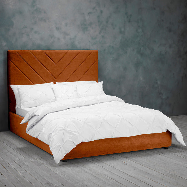 Beautiful Burned Orange Kingsize Bed upholstered in velvet with geometric headboard