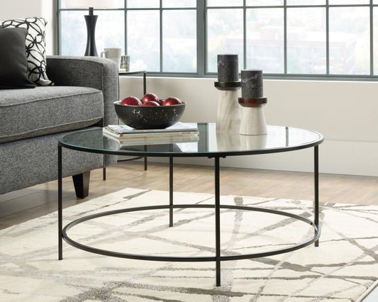 Round coffee table with glass top and black metal frame